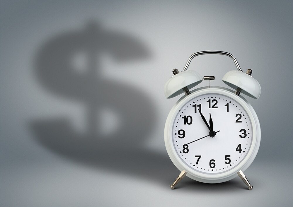 Clock with dollar sign shadow as time is money for employees.
